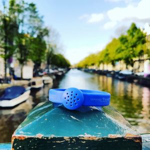 Electric blue rubber bracelet diffuser (boats in background)